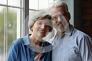 Portrait of happy elderly man and woman hug showing love