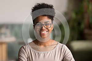 Headshot portrait of happy mixed race african girl wearing glasses