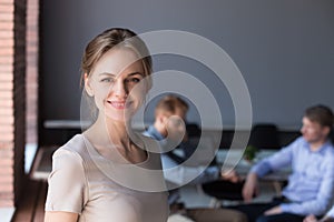 Headshot portrait of happy successful female professional at off photo