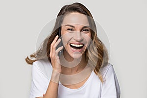 Headshot portrait laughing woman talking on mobile phone studio shot