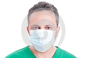 Headshot or portrait of a man doctor wearing surgeon mask