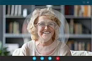 Headshot portrait of mature woman talk on video call