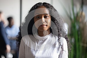 Headshot portrait serious confident african ethnicity businesslady looking at camera