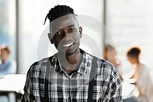 Headshot portrait of smiling African American man in office