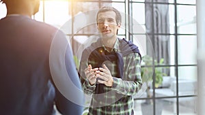 Headshot portrait of a smiling businessman offering a handshake. Business concept