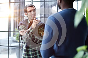 Headshot portrait of a smiling businessman offering a handshake. Business concept