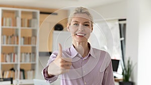 Headshot portrait of smiling businesswoman show thumb up