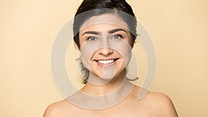 Headshot portrait of smiling Indian woman naked on background