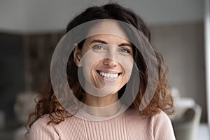 Headshot portrait of smiling Latino woman posing