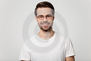 Headshot portrait of smiling man in glasses on studio background photo