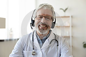 Headshot portrait of smiling senior doctor talk on video call