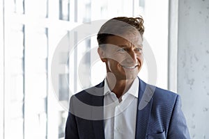 Headshot portrait successful middle-aged businessman posing in office