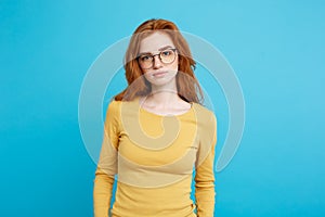 Headshot Portrait of tender redhead teenage girl with serious expression looking at camera. Caucasian woman model with