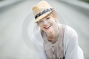 Headshot portrait of young happy woman laughing outdoors