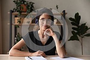 Headshot portrait of young hispanic woman professional teacher wearing headphones