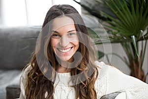 Headshot portrait of young mestizo girl with wide toothy smile photo