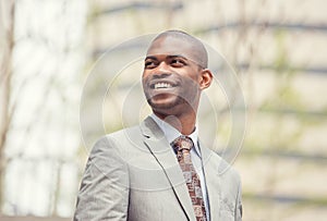 Headshot portrait of young professional man smiling laughing