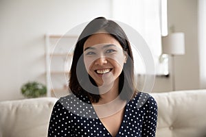 Headshot of smiling Asian girl talk on video call photo