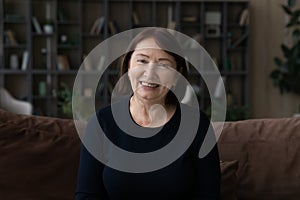 Headshot of smiling elderly grandmother have webcam call