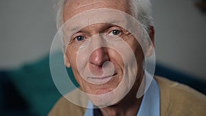 Headshot of smiling handsome senior Caucasian man looking at camera. Close-up portrait of confident male retiree with