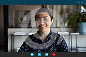 Headshot of smiling indian woman speak on video call