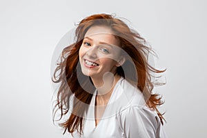 Headshot Of Smiling Red-Haired Young Female Over Gray Background