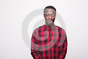 Headshot of surprised young african american man student wearing casual at camera with shocked look, expressing astonishment and s