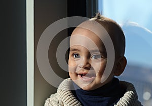 Headshot of a toddler with big smile under sunlight
