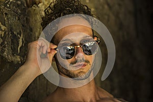 Headshot of unshaved handsome man wearing sunglasses