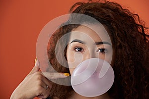 Headshot of woman with bubble gum ball