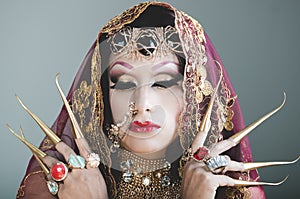 Headshot woman dressed in traditional hindu clothing, heavily decorated in gold and elegant veil, extremely long