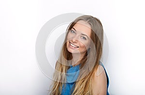 Headshot of young adorable blonde woman with cute smile wearing big black professional monitoring headphones against white studio