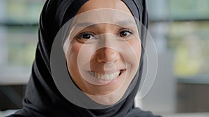 Headshot of young attractive arab woman in hijab looking at camera beautiful muslim girl with natural make-up posing