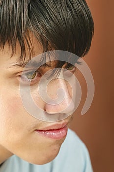 headshot of a young man with green eyes