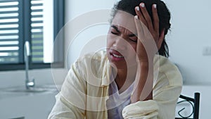 Headshot of young multiethnic woman suffering from terrible headache, migraine or pain due to elevated cranial pressure