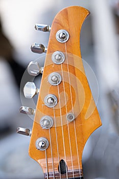 Headstock of the six string classic electric guitar close up