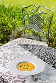 Healhty homemade pumpkin soup with herb on white plate, product photography for restaurant and gastronomy