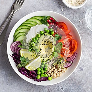 Healhty vegan lunch bowl. Avocado, quinoa, tomato, cucumber, red