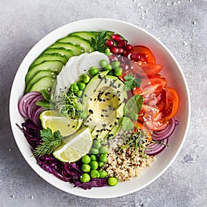Healhty vegan lunch bowl. Avocado, quinoa, tomato, cucumber, red