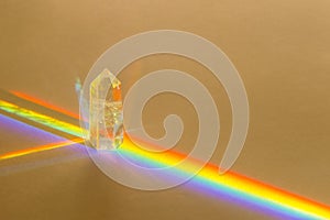 Healing chakra crystal and rainbow on beige background. Meditation, reiki and spiritual healing concept