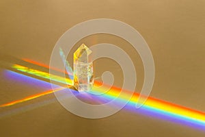 Healing chakra crystal and rainbow on beige background. Meditation, reiki and spiritual healing concept