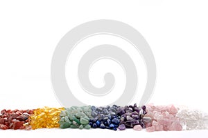 Healing Chakra Crystals Banner - Chakra colored tumbled healing stones. Crystal healing background