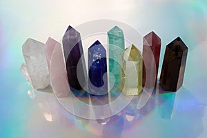 Healing Chakra crystals on halographic background. Meditation, Reiki or spiritual healing background. photo