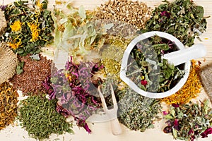 Healing herbs on wooden table, herbal medicine photo