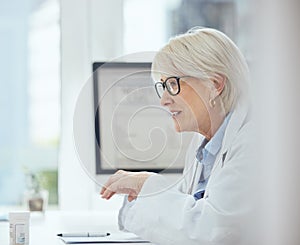 Healing people one checkup at a time. a mature female doctor working at a hospital.