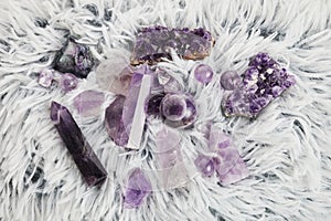 Healing purple amethyst stones on white background. Crystals for ritual