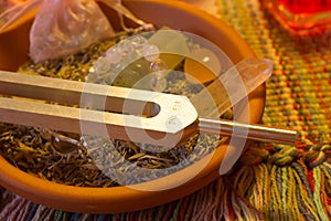 Healing tuning fork and crystal stone on table .