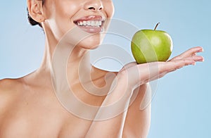 Health, beauty and woman with an apple and a wellness, healthy and organic lifestyle in studio. Girl with clear skin and