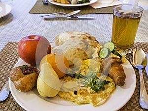 Health breakfast background, fruits, croissant, omlette, juice, pita with hummus