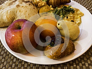 Health breakfast background, fruits, croissant, omlette, juice, pita with hummus